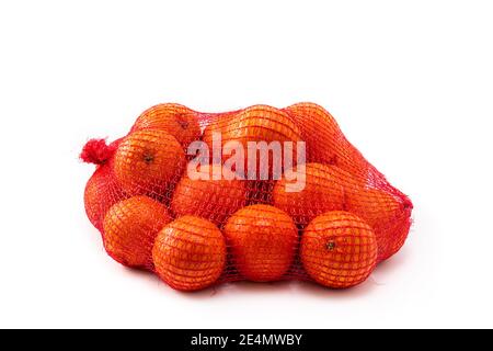 Mesh bag of fresh oranges isolated on white background Stock Photo