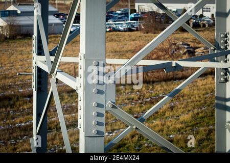 The connection of metal parts with bolts and nuts and metal bars. Large bolts and nuts on the electric pole Stock Photo
