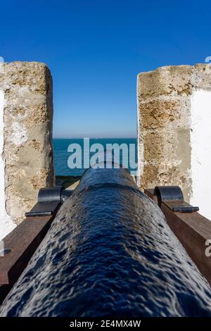 view of the old city wall and battlements with historic cannon in the harbor of Cadiz Stock Photo