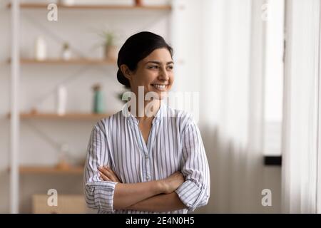 Successful millennial indian lady stand keeping arms crossed on chest Stock Photo