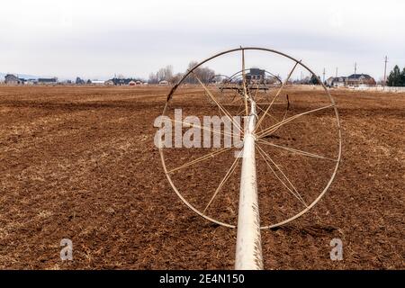 Agriculture water system in winter on a muddy field Stock Photo