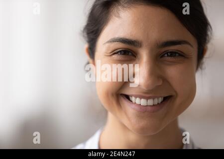 Beautiful indian lady look at camera demonstrate snow white smile Stock Photo