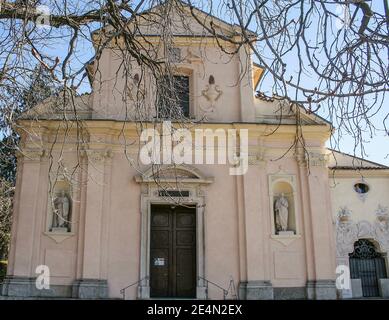 Luino, Province of Varese, region Lombardy, Lake Maggiore (Lago Maggiore). Chiesa di San Pietro (St. Peter's Church). It is the oldest church in Luino, as evidenced by the refined and elegant Romanesque bell tower which is dated by medieval art historians to 1050-1075. The church, on the other hand, was renovated in the mid-seventeenth century with a three-nave layout. Stock Photo