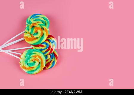 Several colorful lollipops on pink background Stock Photo