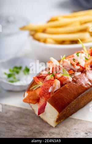 Lobster roll with fries on a marble board Stock Photo