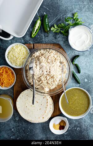 Making enchiladas with shredded chicken Stock Photo