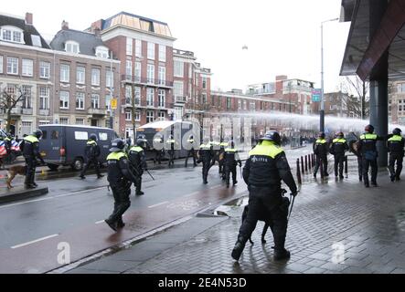 Amsterdam, Netherlands. 24th Jan, 2021. Dutch anti-riot police use water cannon to disperse an illegal anti-lockdown demonstration at the Museumplein amid the coronavirus pandemic on January 24, 2021 in Amsterdam, Netherlands. (Photo by Paulo Amorim/Sipa USA) Credit: Sipa USA/Alamy Live News Stock Photo