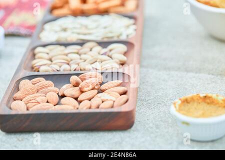 Assorted snacks and a bowl of chips on white table Stock Photo