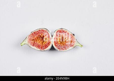 Half slices of ripe fig on a white background Stock Photo