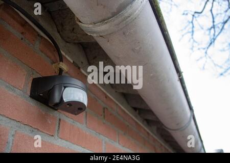 Motion detector sensor for outdoor lighting. For security and saving energy Stock Photo
