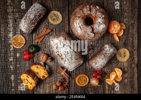 Christmas composition of dried fruits and stollen, with tangerine, on a wooden textured table, with spices. At Christmas. Stock Photo