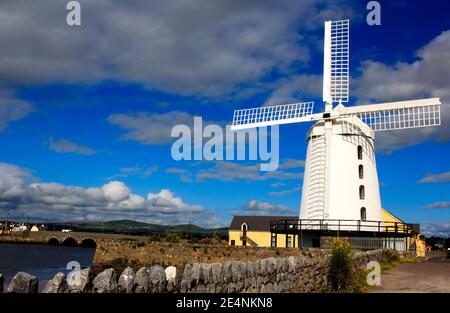 Blennerville Windmill - white windmill with the blue sky with clouds background in Tralee Bay (town of Blennerville, Ireland). Stock Photo