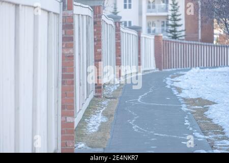 wood wall beside a walkway pavement in city Stock Photo