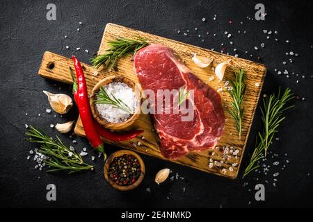 Raw beef steak with herbs. Stock Photo