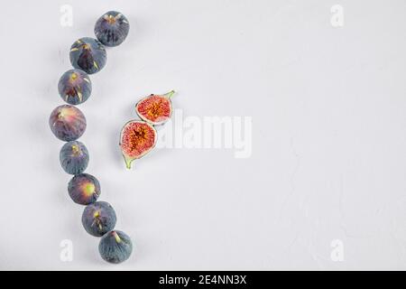 Whole fig and fig slices on a white background Stock Photo