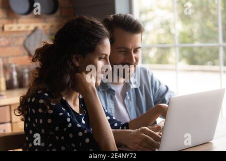 Happy couple use laptop shopping online on gadget Stock Photo