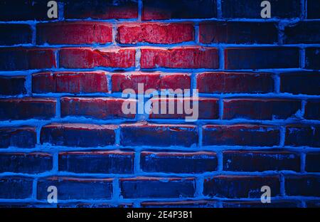 Brick wall texture background in red and blue neon lights Stock Photo