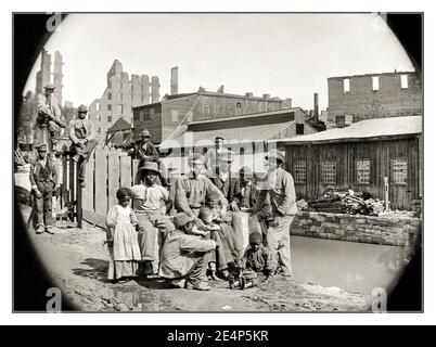 SLAVERY SLAVES AMERICA June 9, 1865. “Black African Americans freed from slavery group together for a photograph by a canal —  at Haxall’s Mill, Richmond.” USA Part of a Wet plate stereograph by Alexander Gardner. Stock Photo