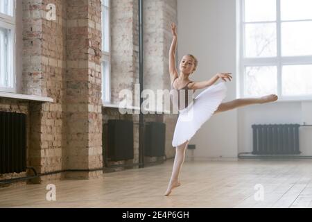 Adorable child dancing classical ballet in a white studio Stock Photo