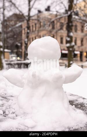 Snowman, snow woman molded from snow. Snowy winter concept. High quality photo Stock Photo