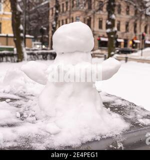 Snowman, snow woman molded from snow. Snowy winter concept. High quality photo Stock Photo