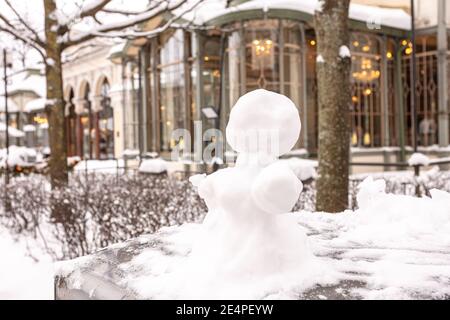 Snowman, snow woman molded from snow. Snowy winter concept. High quality photo Stock Photo