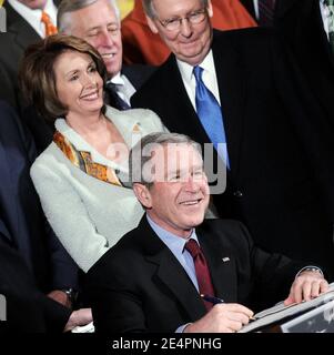 House Speaker Nancy Pelosi stands behind U.S. President George W. Bush as he signs H.R. 5140, during an East Room event at the White House February 13, 2008 in Washington, DC. Bush has signed the Economic Stimulus Act of 2008 into law. Photo by Olivier Douliery /ABACAPRESS.COM Stock Photo