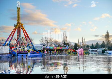 Stourport-on-Severn, UK. 23rd January, 2021. Flood water in Stourport-on-Severn has completely covered the car park next to the fairground having earlier burst the banks of the river. Stock Photo