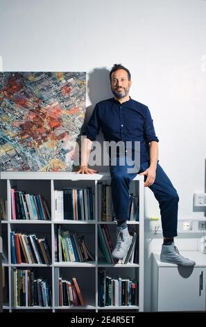 England / London /Forensic Architecture/ Eyal Weizman, the founder of Forensic Architecture sitting next to a satellite image from Rafah. Stock Photo