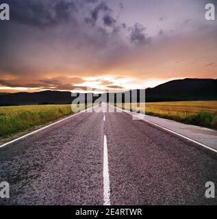 asphalt road with line marking and cloudy sky Stock Photo - Alamy