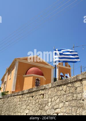 Greek flag flying outside church in Xanthates, Corfu, Greece Stock Photo
