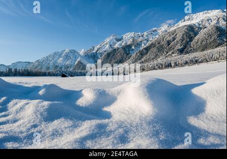 Snow covered rocky Austrian Alps with blurred sparkeling snow heaps, Wildermieming, Tirol, Austria Stock Photo