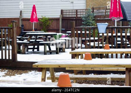 Snow blanket tables and chairs in the garden Stock Photo