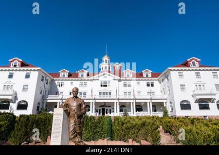 Estes Park, CO - October 31, 2020: Exterior of the historic Staley Hotel in Estes Park near Rocky Mountain National Park with statue of F. E. Stanley Stock Photo