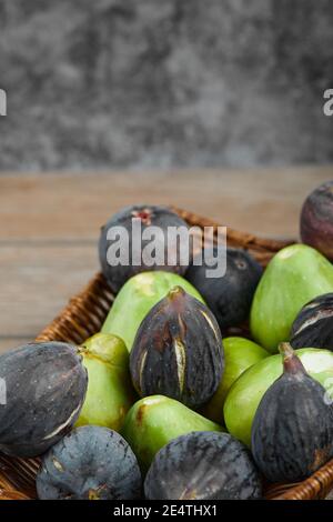 Ripe green and black figs in a basket Stock Photo