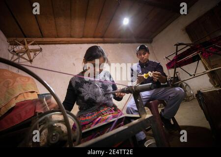 Family using a new solar-powered lighting system at their home in Cantel, Guatemala, Central America. Stock Photo