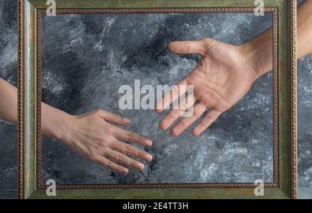 Male and female showing hands in middle of picture frame Stock Photo