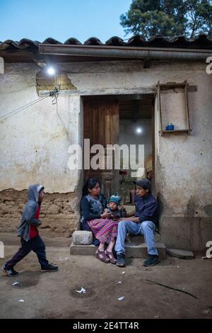 Family using a new solar-powered lighting system at their home in Cantel, Guatemala, Central America.