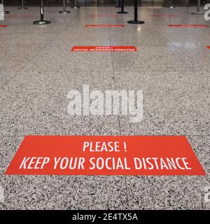 Signs on the floor about social distancing during pandemic of Covid-19 Stock Photo