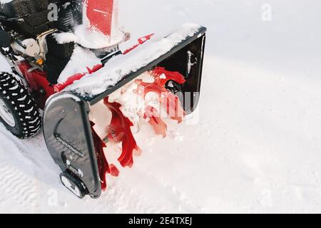 Red-black snowblower machine in the process of work Stock Photo