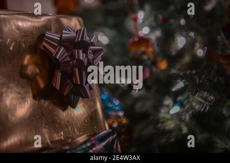 Christmas presents with gift tags - Christmas pile - wrapped gifts - present with gift tag under a Christmas tree - Christmas decorations and bows Stock Photo