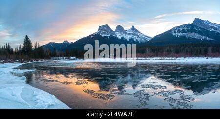 Scenic Sunset Sky Landscape Panorama Three Sisters Mountain Peak Bow River Ice Water Reflection Cold Winter Canmore Alberta Foothills Canadian Rockies Stock Photo