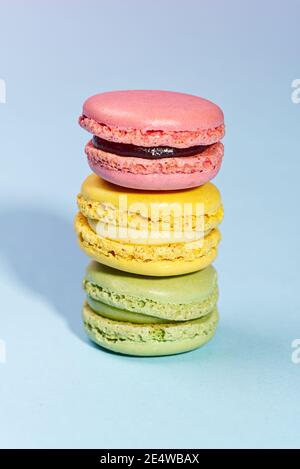 Macaron. Traditional french colorful macarons close up, macro on blue background Stock Photo