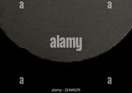 round slate plate over black background Stock Photo