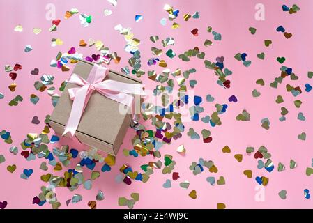 Valentine's day pink background with pink gift boxes and heart shape confetti Stock Photo