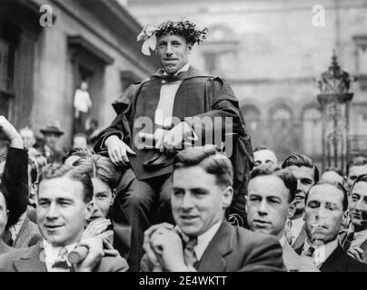Eric Liddell (1902-1945) being carried around Edinburgh University on July 18, 1924, after winning the Gold Medal for the 400 metre race in the 1924 Paris Summer Olympics. The following year, Liddell, a devout Christian, went to China as a missionary. Aside from two furloughs in Scotland, he remained in China until his death in a Japanese civilian internment camp in 1945. Stock Photo
