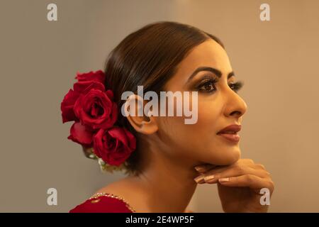 Profile of an Indian bride during the make up session Stock Photo