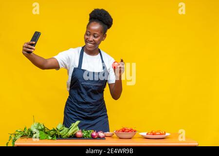 african chef doing a video, showing ingredients to the person on the call Stock Photo