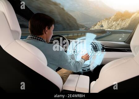 Driver controls an autonomous car using touch screen Stock Photo