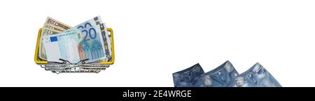 Upper parts of three pairs of blue jeans slightly tilted, dollar and euro bills mixed up in shopping basket on white background. Isolated. Banner. Cop Stock Photo